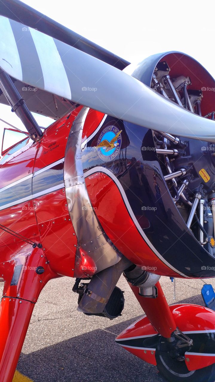 Cherry red Beech Stagger Wing with a Pratt Whitney Wasp Junior 9 cylinder radial 450 HP super charged engine.