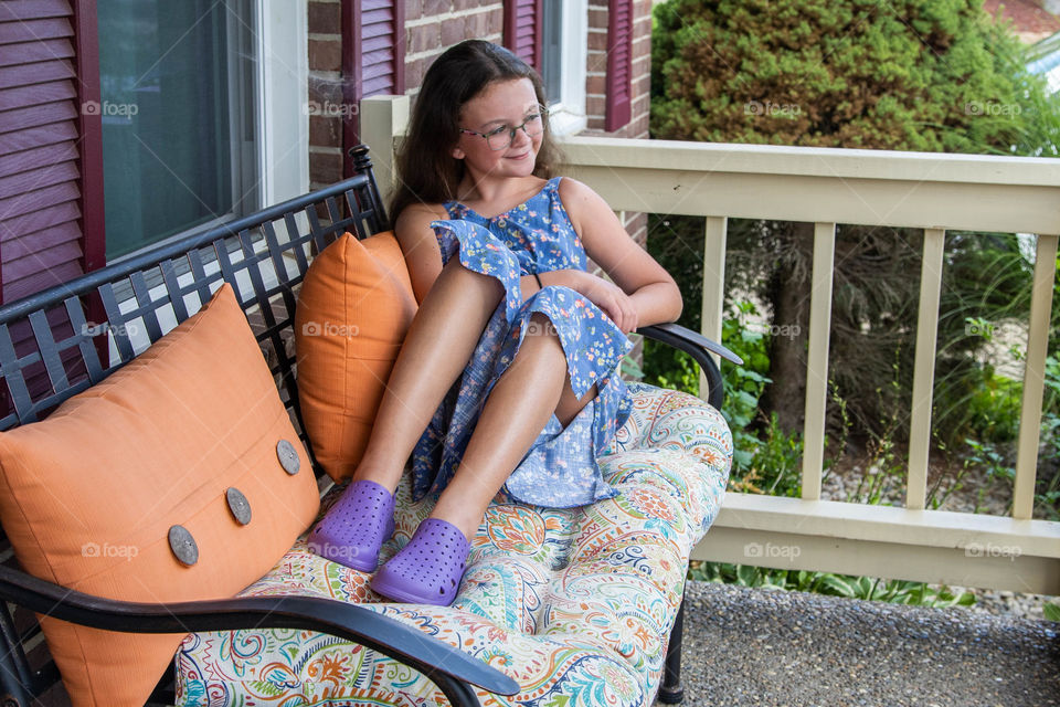 Girl relaxing outdoors on the porch