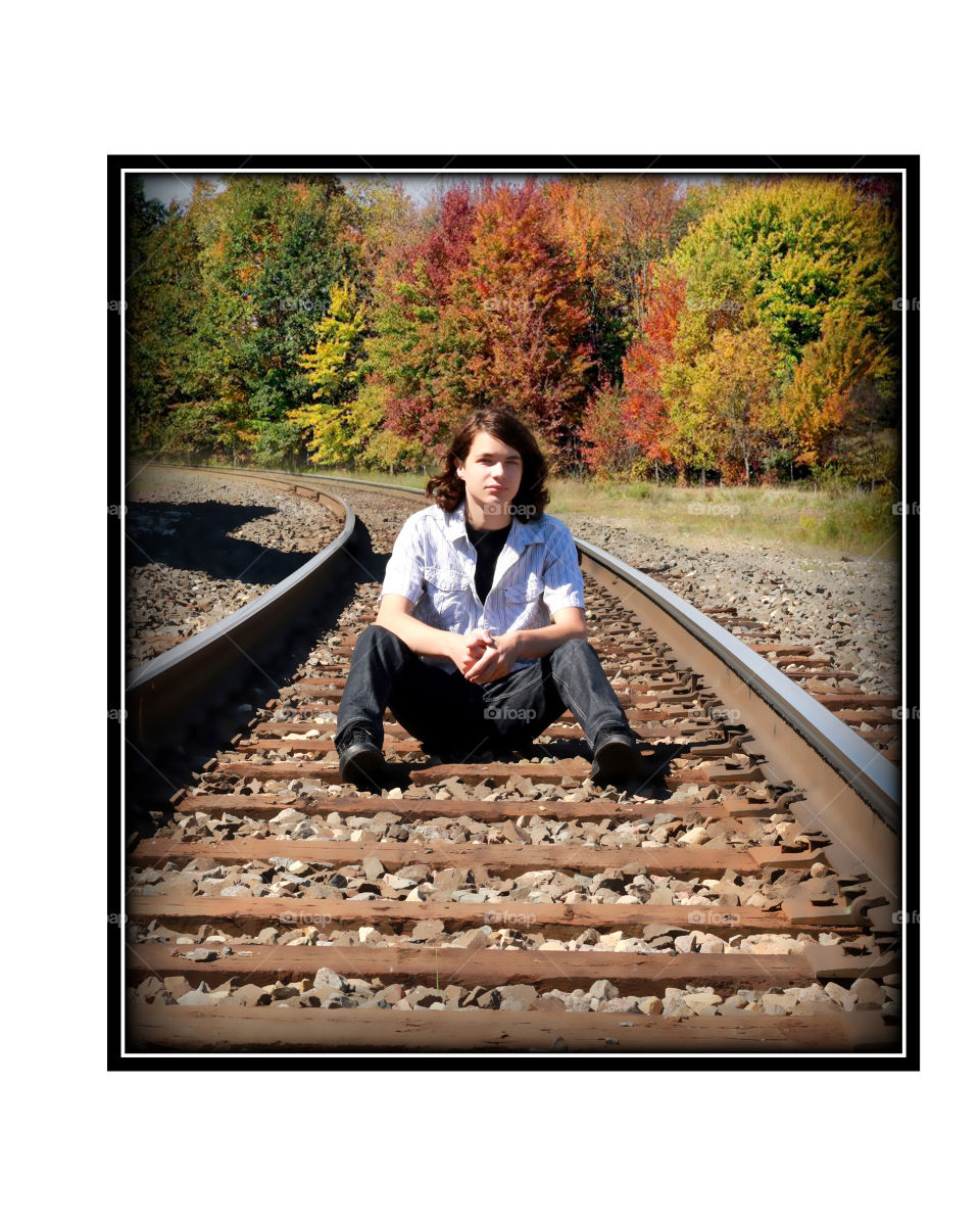 teenage boy on railroad tracks