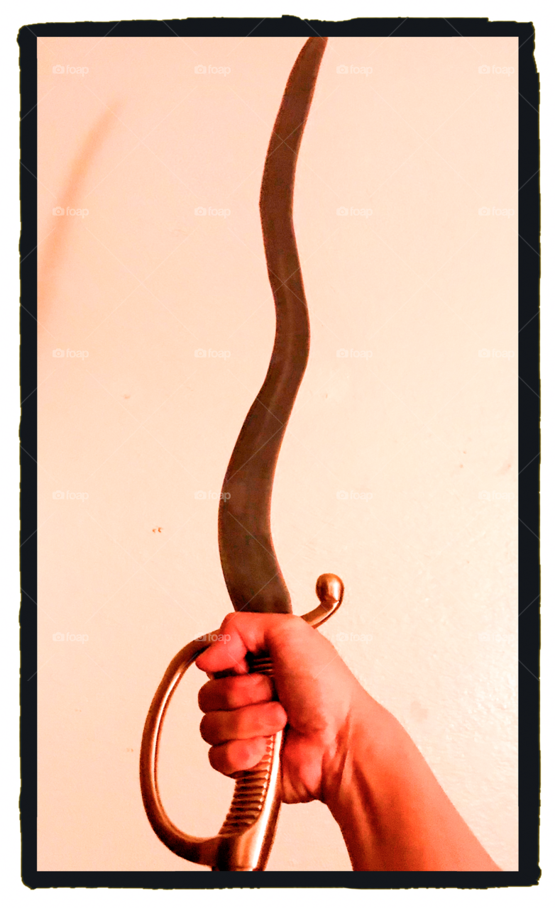 A French infantry shot sword with a flamberge blade. It is wavy like a slithering snake.