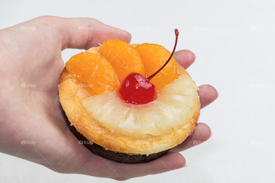 Person holding fruits cake