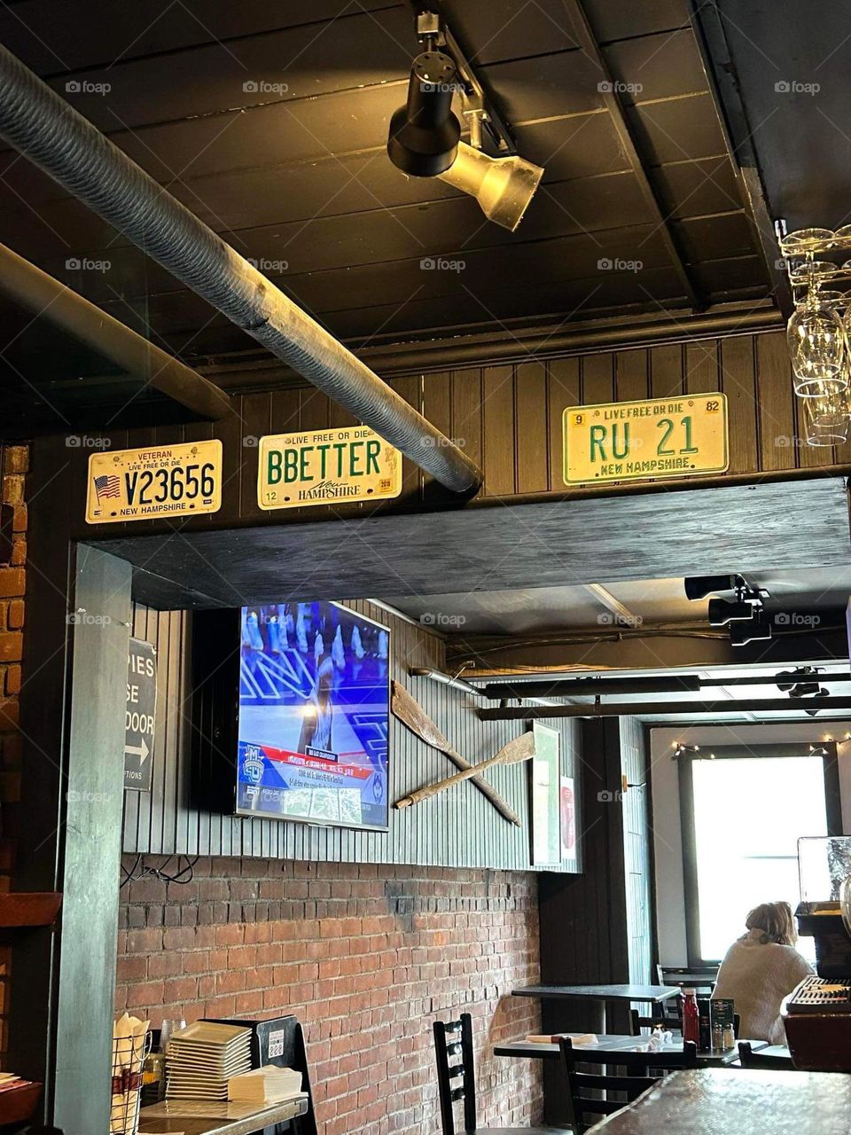 License plates inside a bar, sitting in a bar, view from a bar stool, drinking at a bar, bar decor 