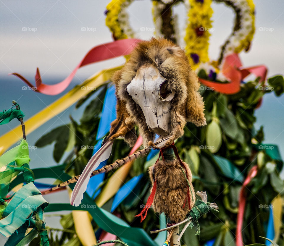 An animal skull on a staff is lifted aloft in front of “The Jack” at a bizarre English folk festival, in Hastings