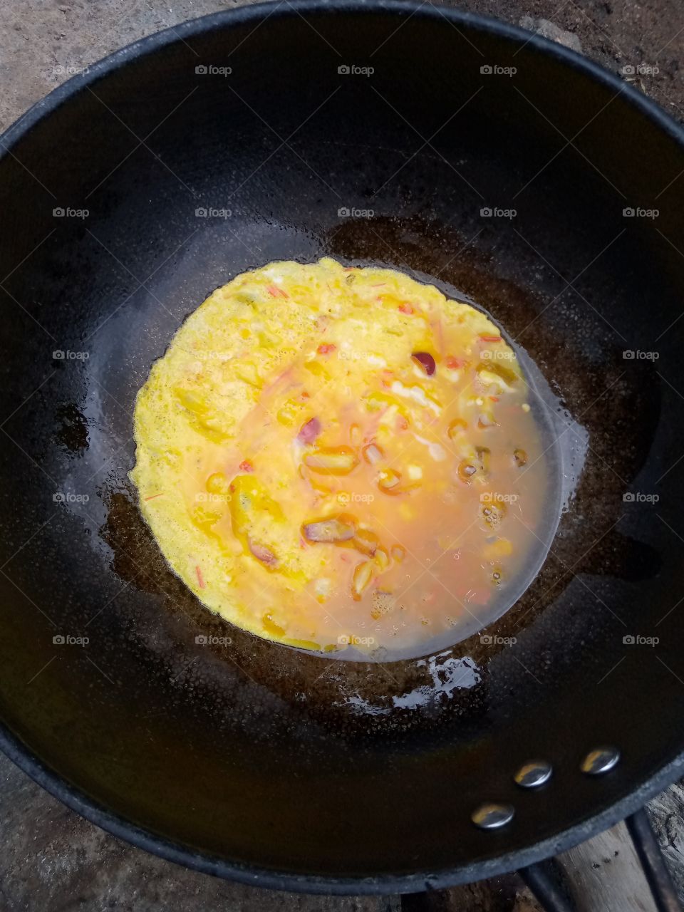 mousle eggs, poured into the frying pan and the frying process began and some parts of the mousle eggs are becoming fried