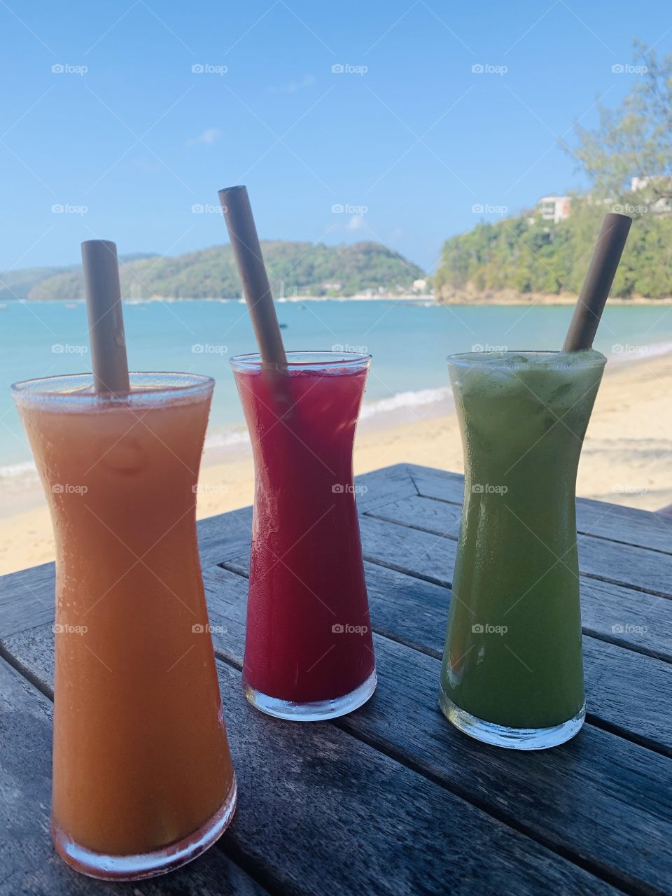 Coloured drinks on the beach