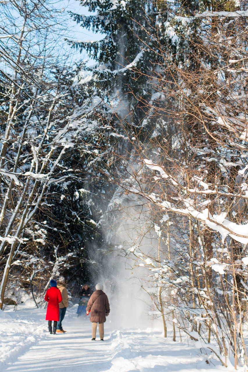 People walking on snow covered footpath