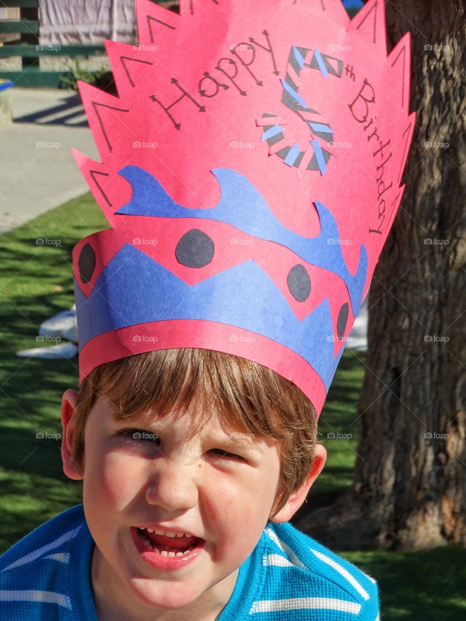 Birthday boy wearing paper crown