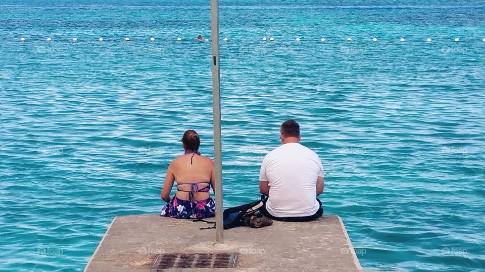 Two people at the end of the dock..Nassau Bahama's