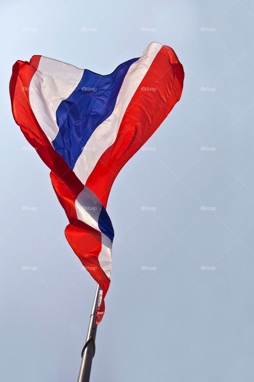 Thai national flag waving atop