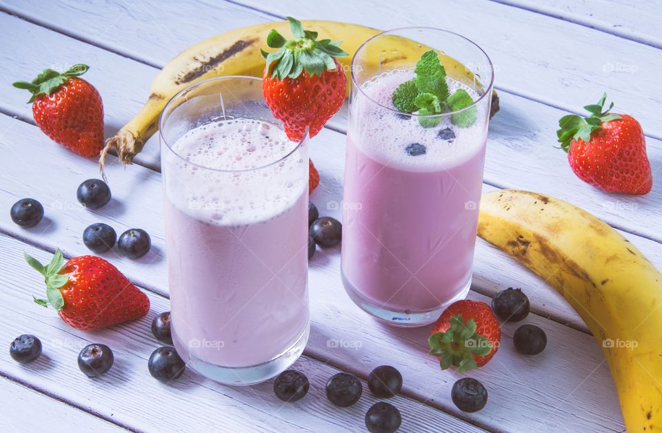 Berry and banana smoothies on table