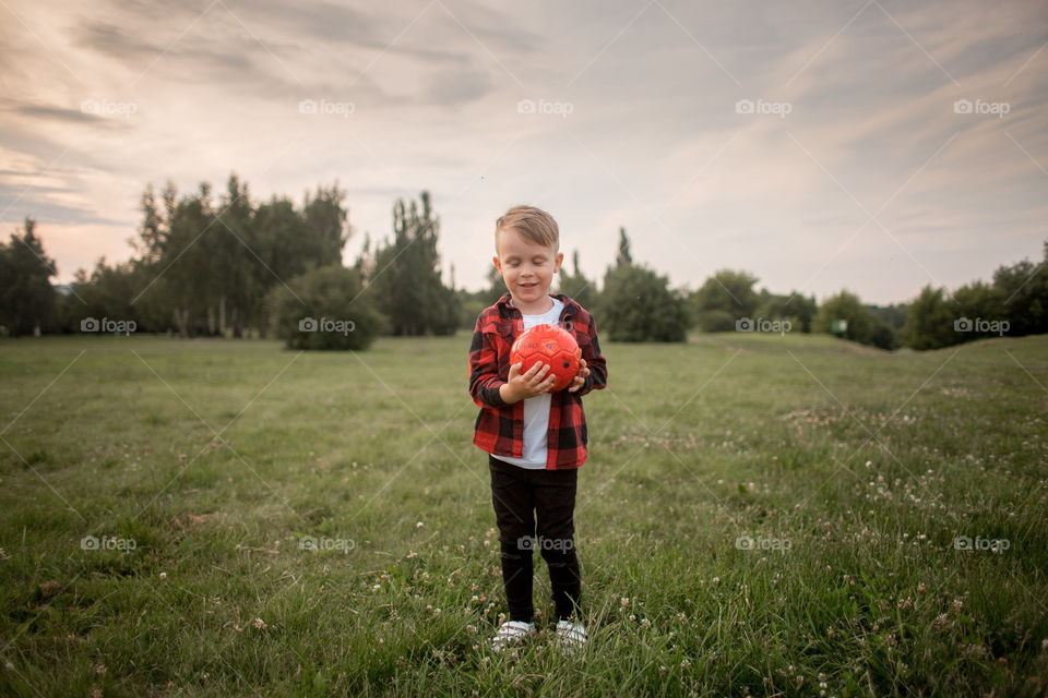 Little boy playing in soccer in a park 