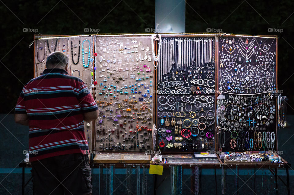 Street Seller Of Handmade Rings, Bangles, Earrings And Souvenirs At Night
