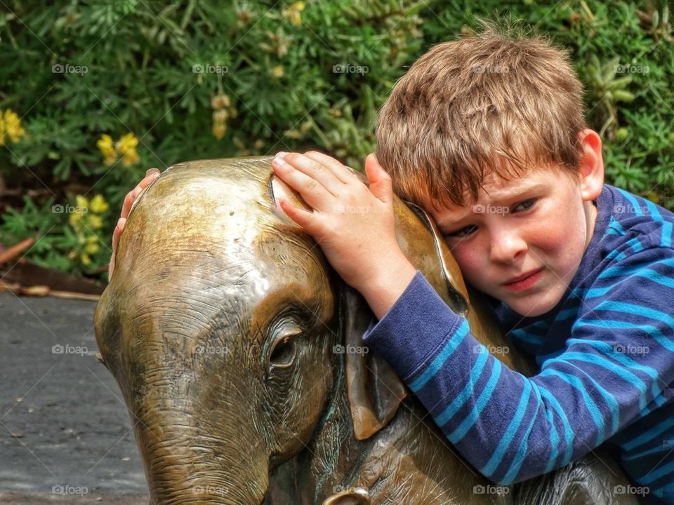 Sad Boy Hugging Elephant