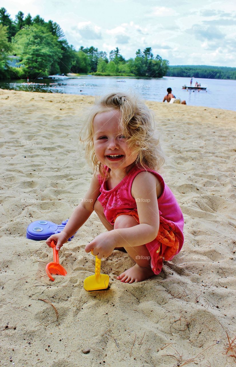 Girl playing with sand at beach