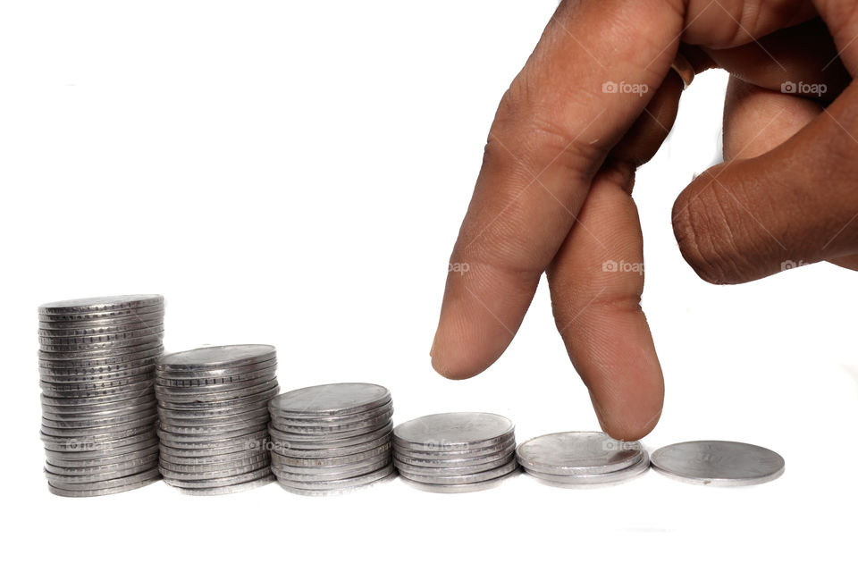 Business man putting fingers on coin and looking for profit growth up, Collecting money with earning bank deposit interest. Business ideas concept isolated white background.