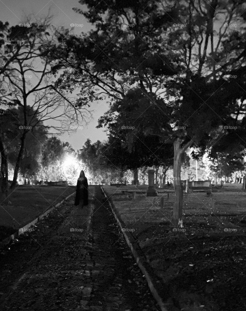 Cloaked figure in graveyard 