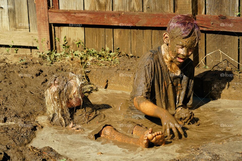 Kids Playing In Mud