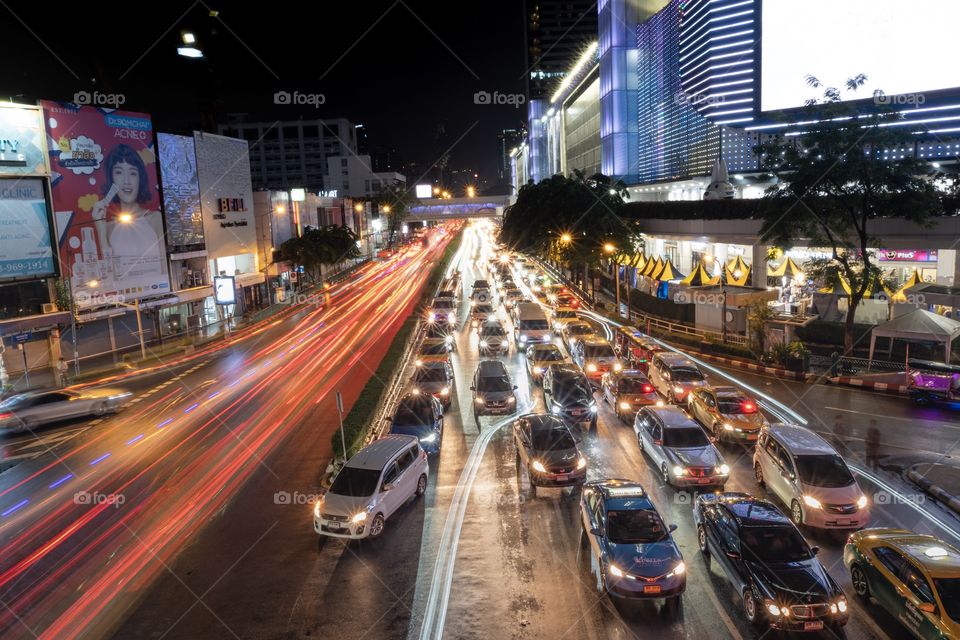 Beautiful Vehicle headlamp light at U turn road in front of the most famous shopping center MBK , Bangkok Thailand