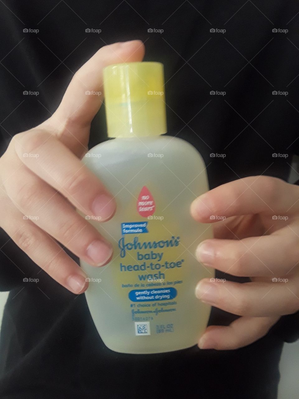 Hands Holding Johnson's Baby Wash Bottle