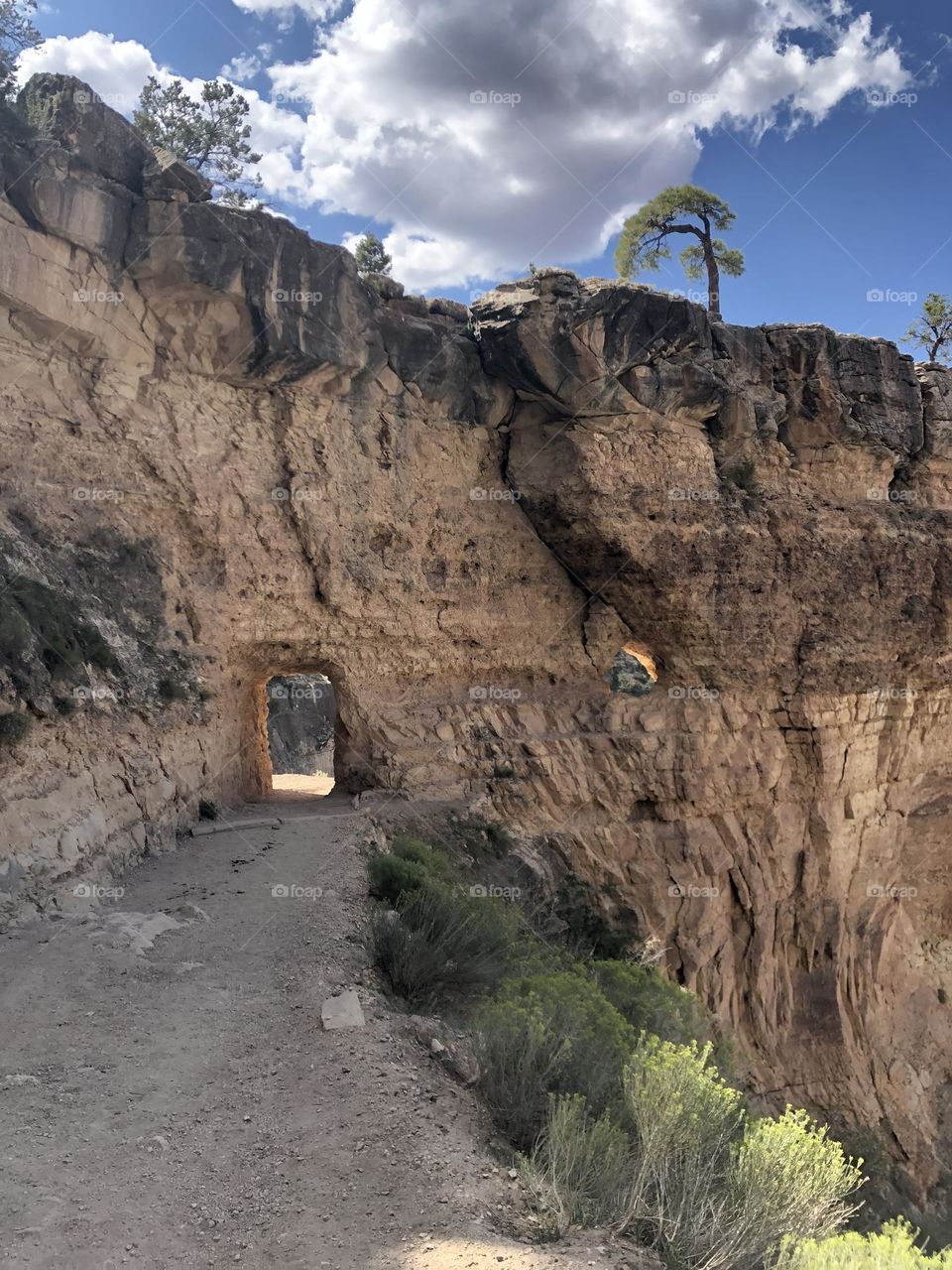 View of hole in the wall of rock at the Grand Canyon on a hike