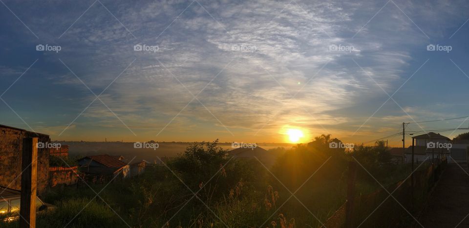 A beautiful sunrise to start a new day in a small city. The first lights in the morning bringing color and life to the city.