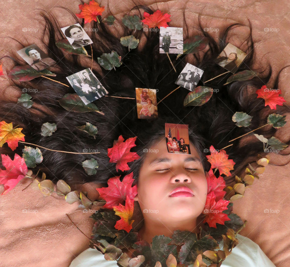 The mood of autumn, girl with leaves and family tree in her hair
