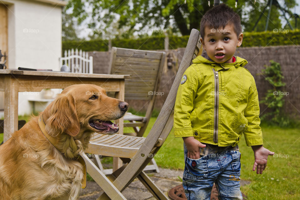young boy with his dog in the garden