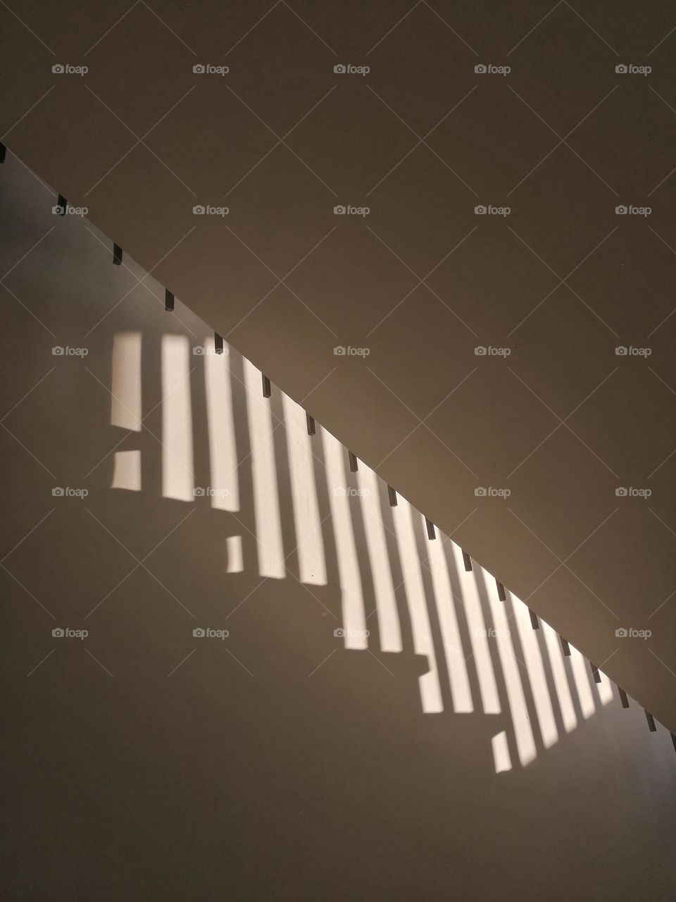 Stairs shadow from the sun shining in the window