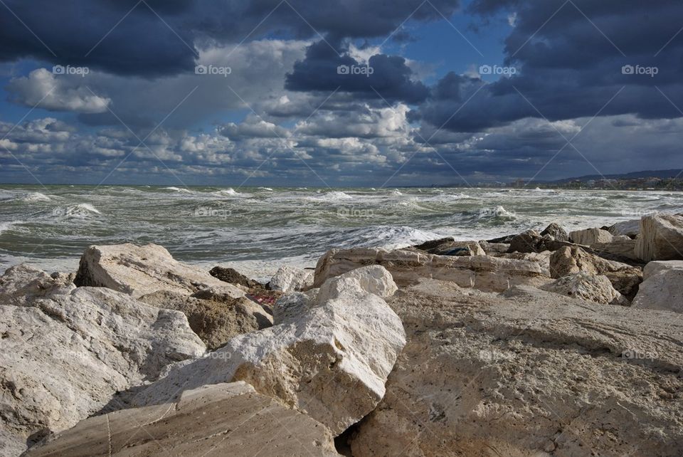 Big mediterranean wave breaking the shore