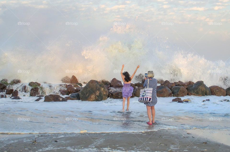 Woman Recording a Video on Stormy Sea