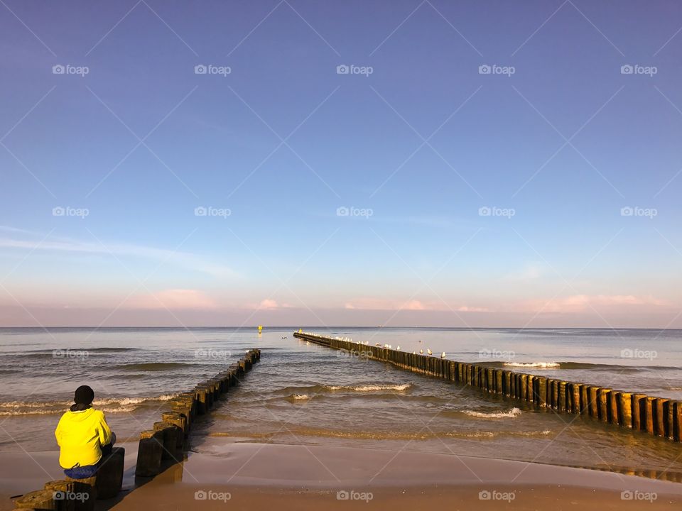 Person at sitting at sea looking at view