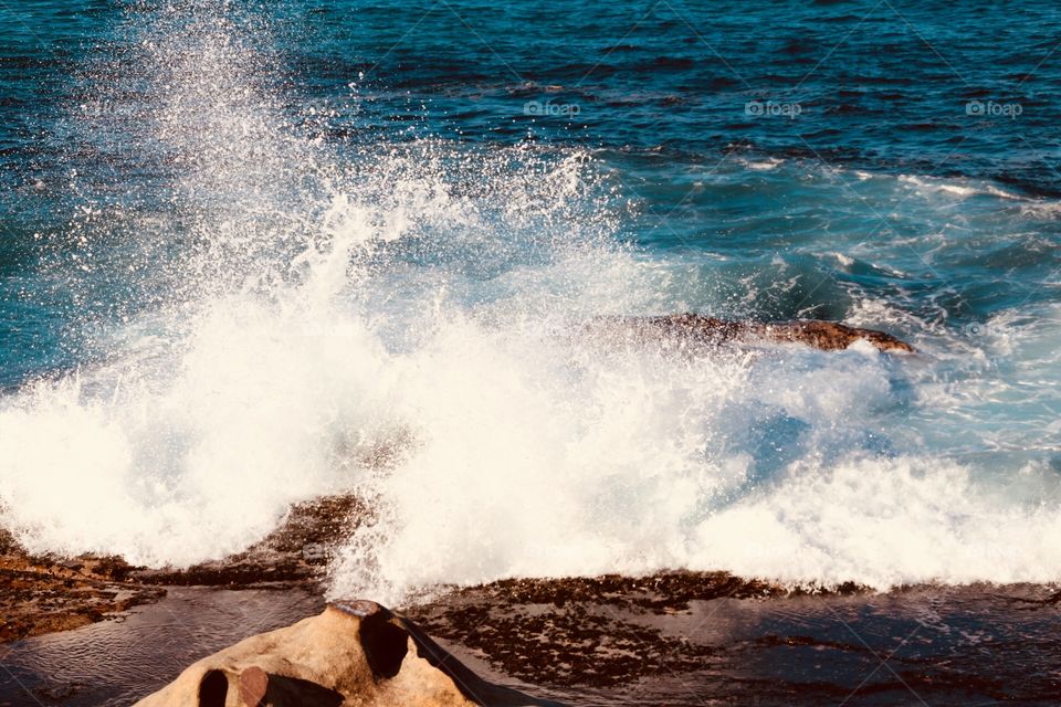 Waves splashing against the rocks on Bondi beach 