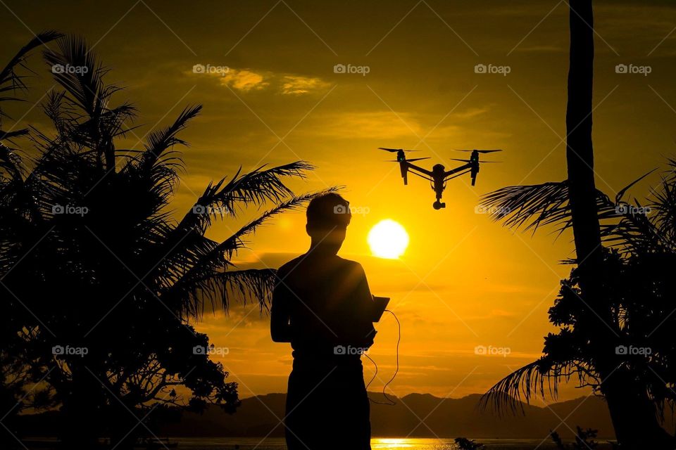 A boy playing his favorite gadget drone