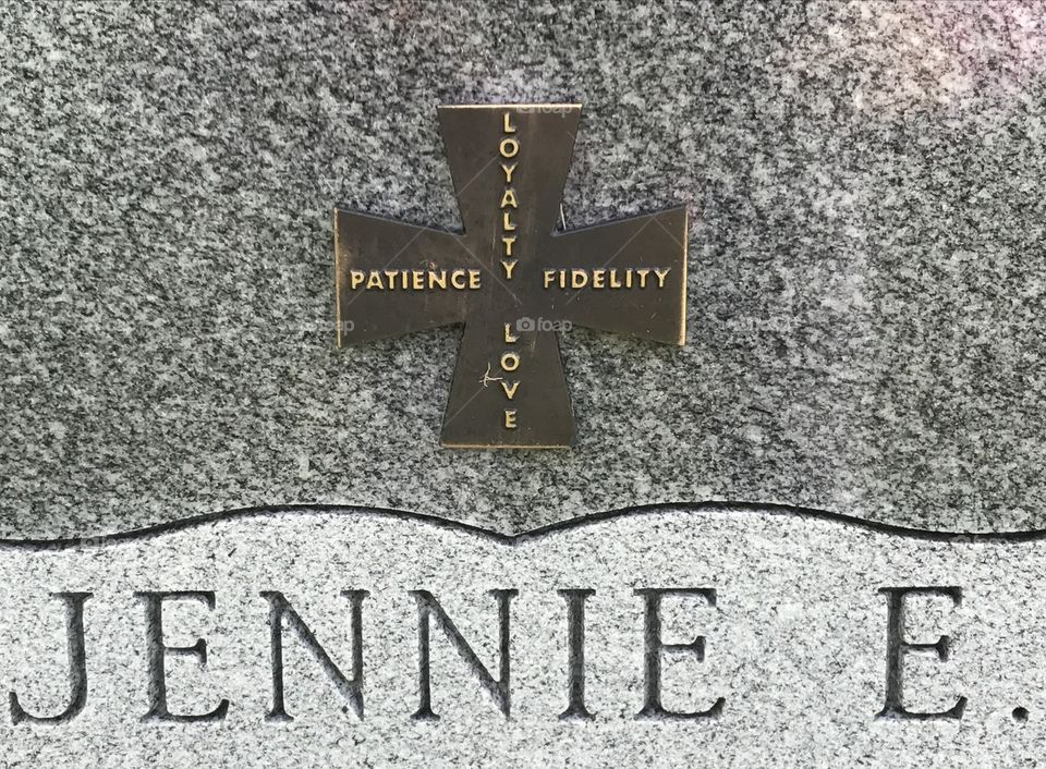 Woman's headstone at a grave at a cemetery 