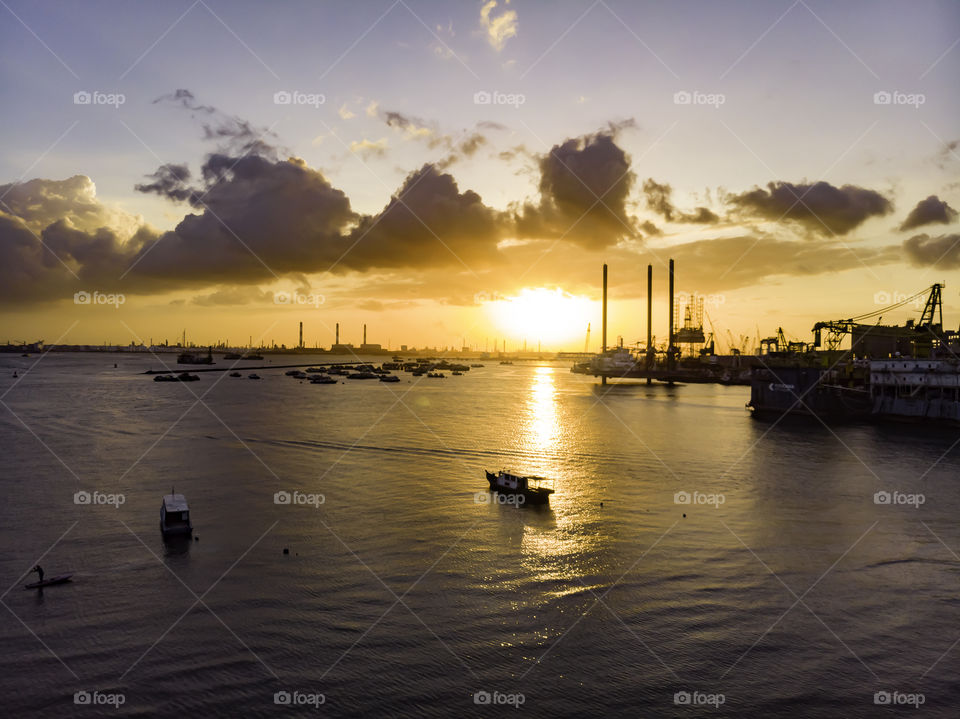 Sunset by the bay. Ships docking nearby.