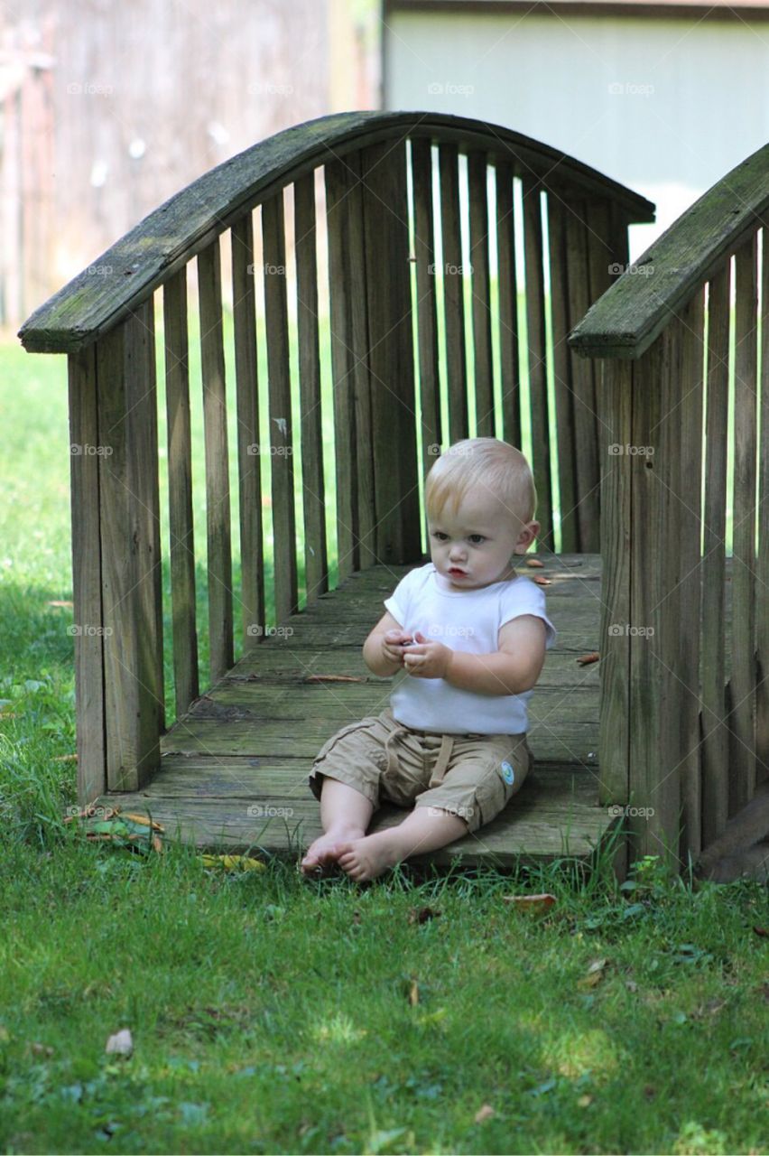 Little boy sitting in park