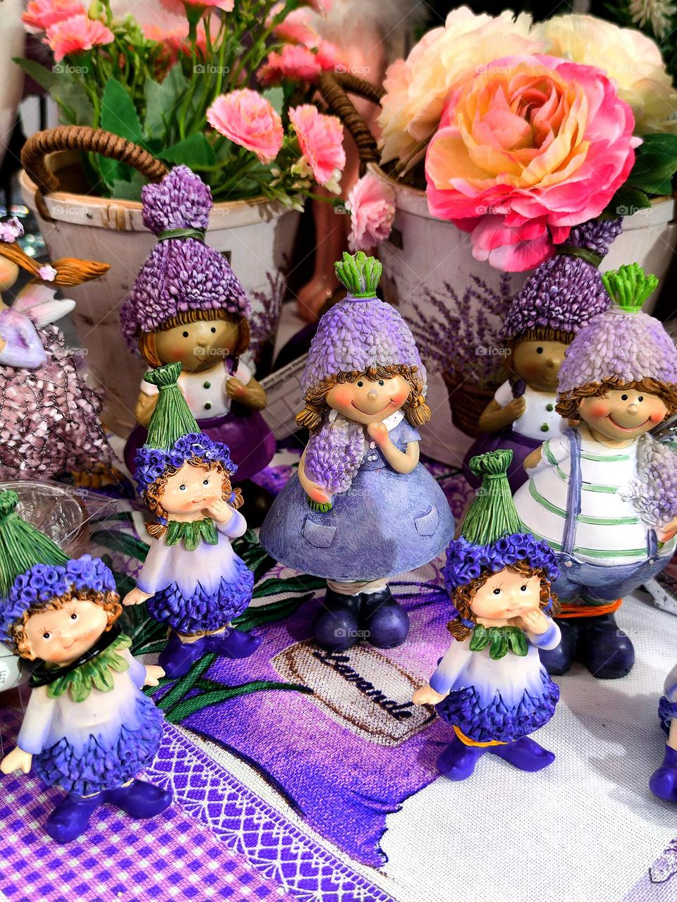 figurines of lavender fairies stand on purple decorative towels.  All shades of purple