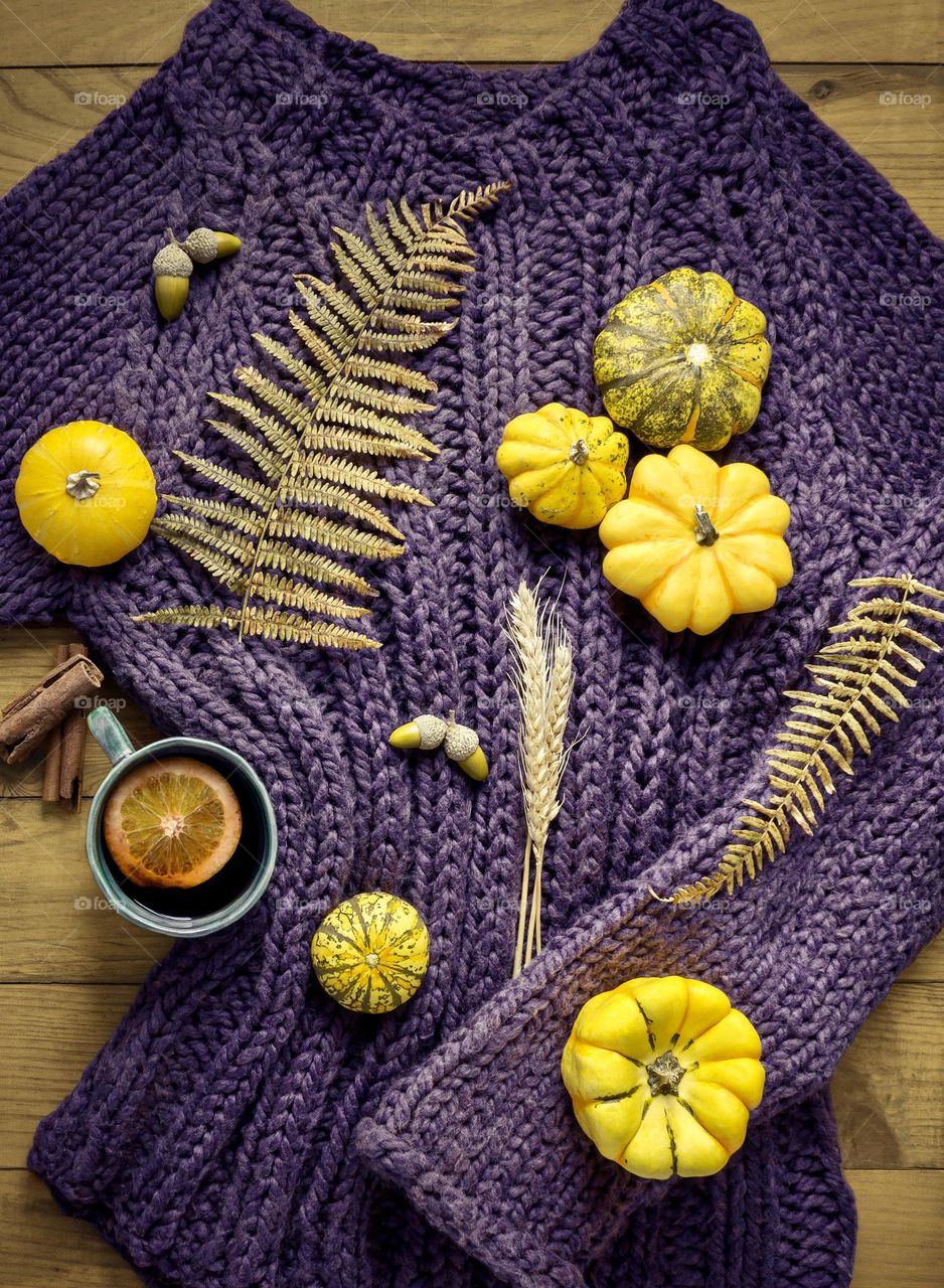 Yellow gourds on a purple pullover