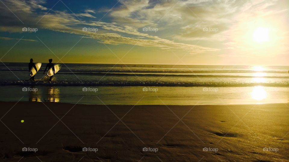 Surf time . Surf with a awesome sunset at Caparica beach -Portugal 