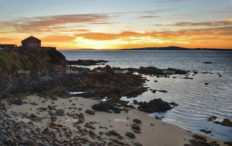 View of the chapel of Our Lady of A Lanzada at sunset, Galicia, Spain.