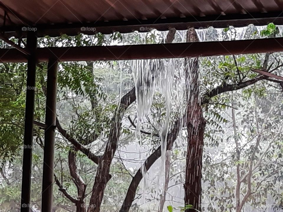 Rain water pouring through asbestos sheet