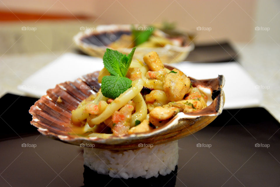 Seafood in scallop shell rice