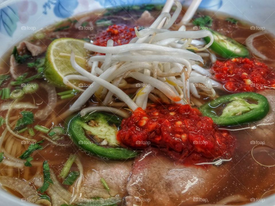 Vietnamese Pho Noodle Soup. Lime, Bean Sprouts And Chili Paste In Vietnamese Pho