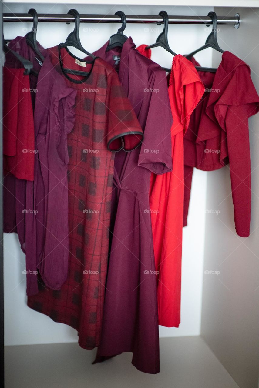 Magenta clothes hang in the closet