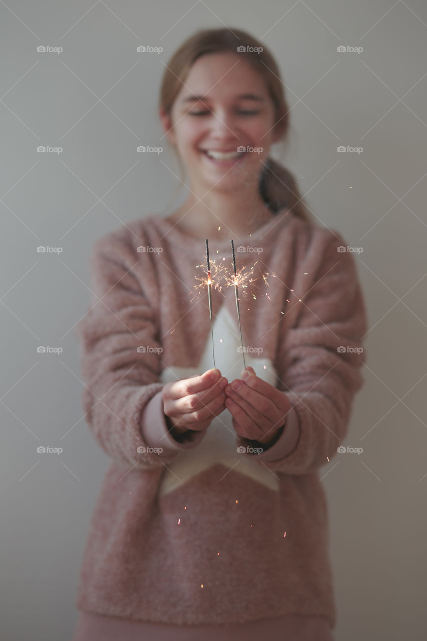 Girl holding sparklers in hand