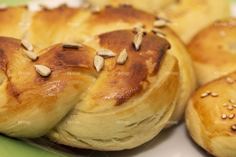 Freshly taken out of the oven sweet homemade pretzels with sunflower seeds topping