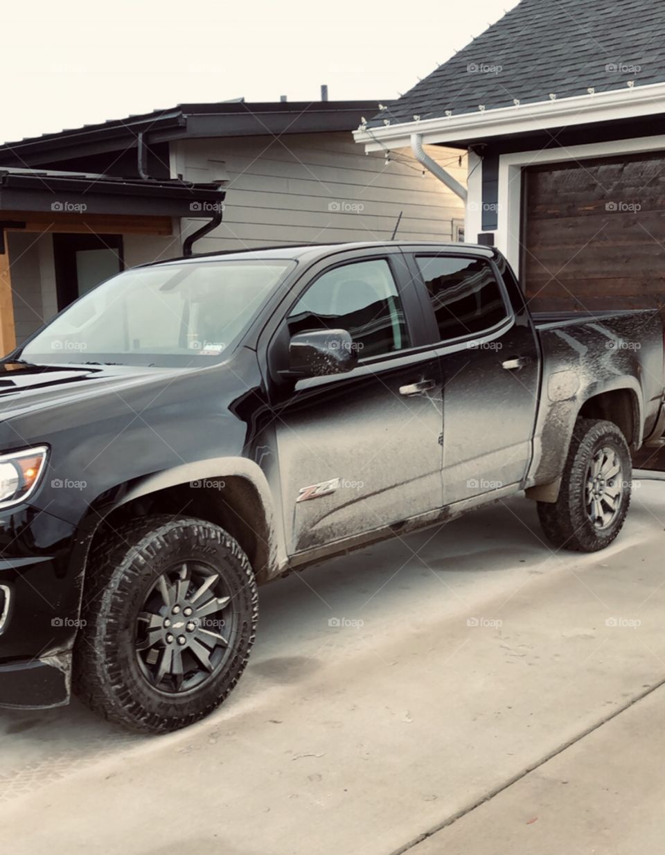 All black Chevy truck covered in mud an hour after getting it washed. Welcome to Montana. 