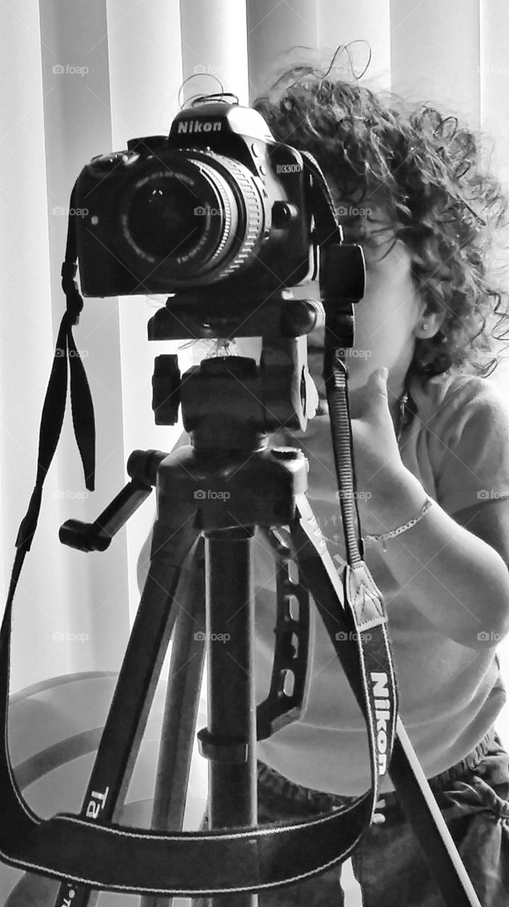 Little boy standing with camera