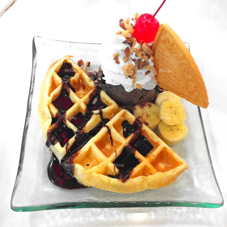 Plate of belgian waffles with ice cream. Plate of belgian waffles with ice cream on table