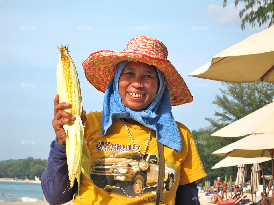 Selling grilled corn with butter on Bangtao beach Phuket Thailand